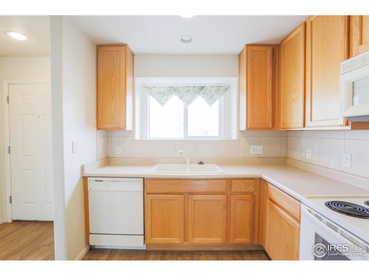 6827 Autumn Ridge Drive, Unit 4 Fort Collins, CO 80525 - Photo 10 of 28 a kitchen with a sink a window and cabinets