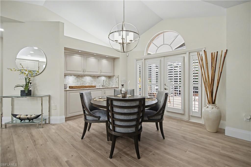 5186 Tallowood Way Naples, FL 34116 - Photo 14 of 50 a view of a dining room with furniture window and wooden floor