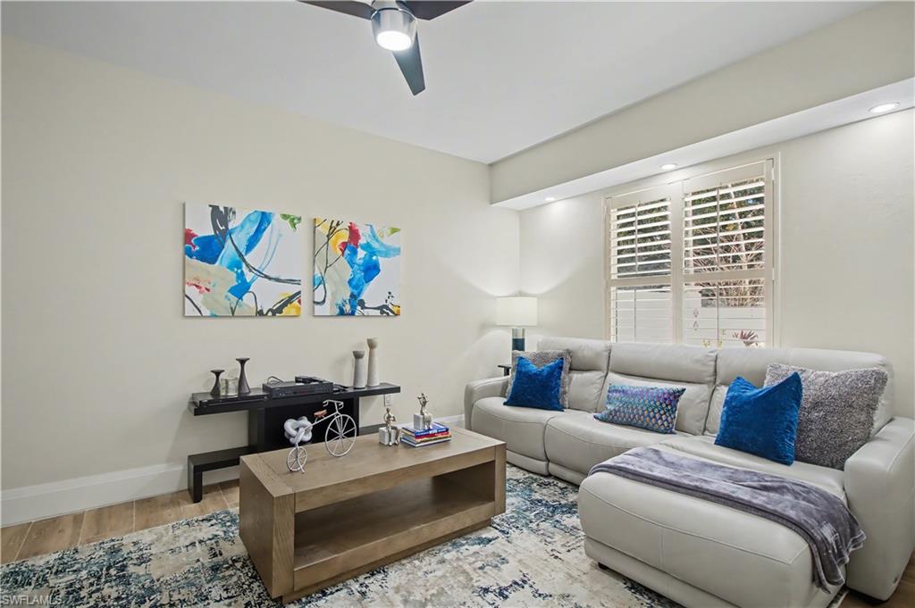 5186 Tallowood Way Naples, FL 34116 - Photo 21 of 50 a living room with furniture and a window