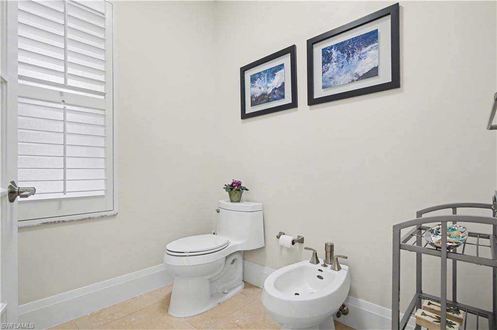 5186 Tallowood Way Naples, FL 34116 - Photo 27 of 50 a bathroom with a toilet a sink and a window