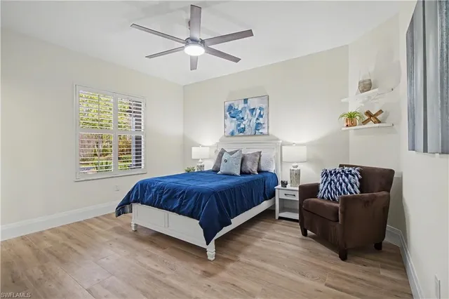 a spacious bedroom with a bed couch and a window
