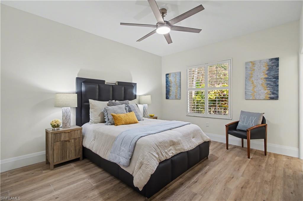 5186 Tallowood Way Naples, FL 34116 - Photo 31 of 50 a bedroom with a bed and a table in it
