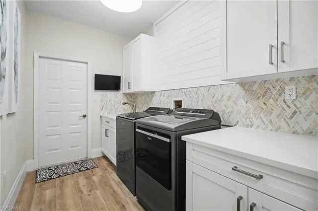 a kitchen with a stove and a white cabinet