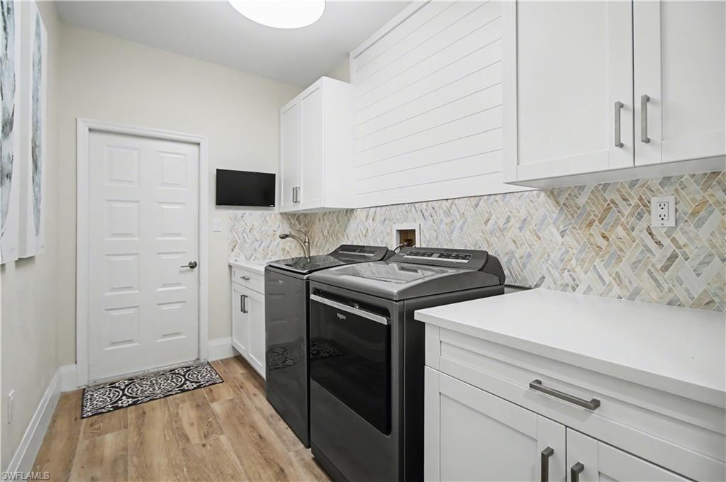 5186 Tallowood Way Naples, FL 34116 - Photo 32 of 50 a kitchen with a stove and a white cabinet