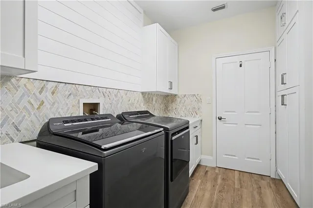 a kitchen with a stove and a wooden floor