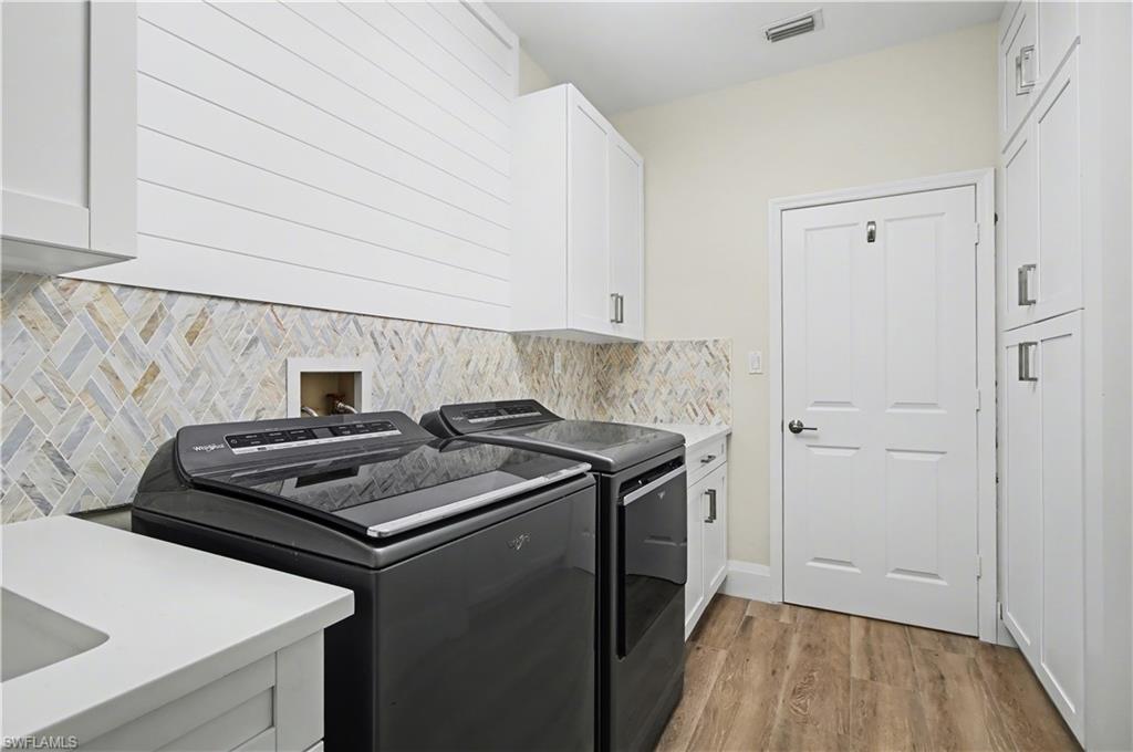 5186 Tallowood Way Naples, FL 34116 - Photo 33 of 50 a kitchen with a stove and a wooden floor