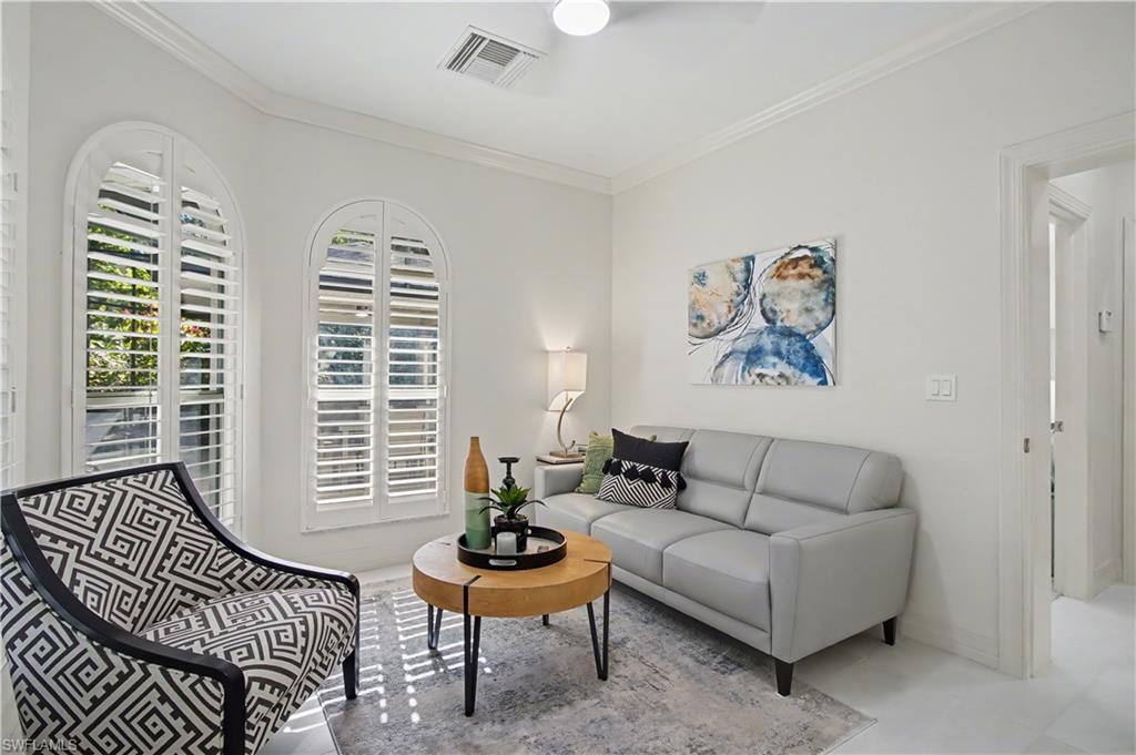 5186 Tallowood Way Naples, FL 34116 - Photo 34 of 50 a living room with furniture and a potted plant