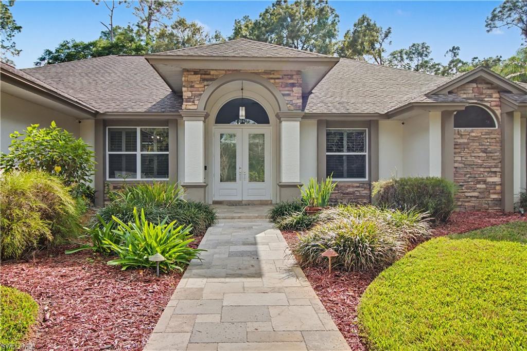 5186 Tallowood Way Naples, FL 34116 - Photo 4 of 50 a front view of a house with garden