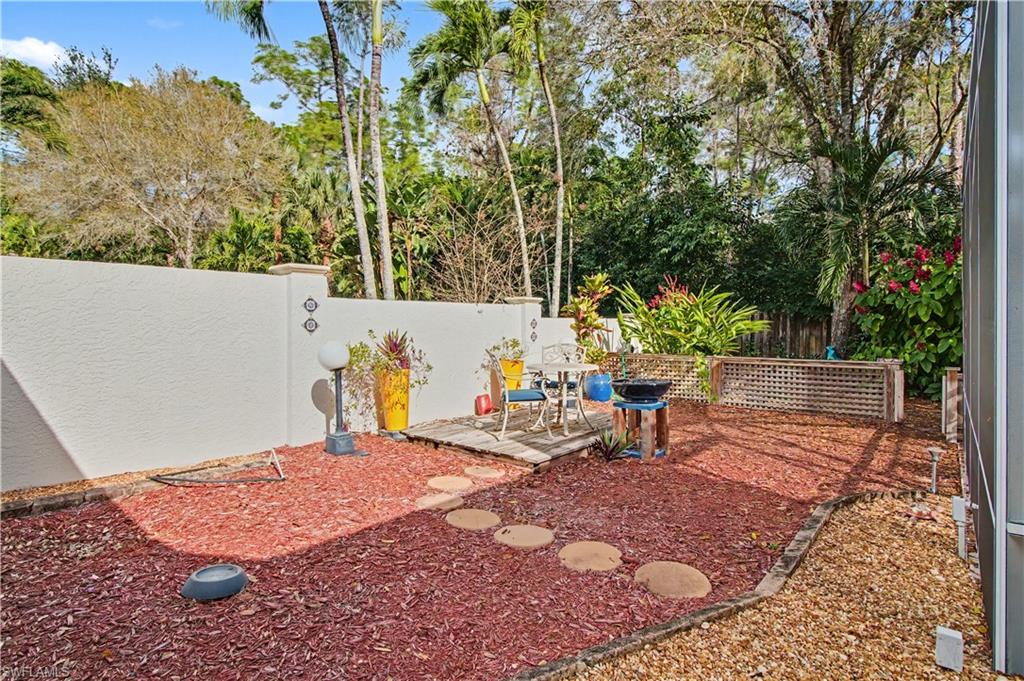 5186 Tallowood Way Naples, FL 34116 - Photo 45 of 50 a view of a backyard with sitting area