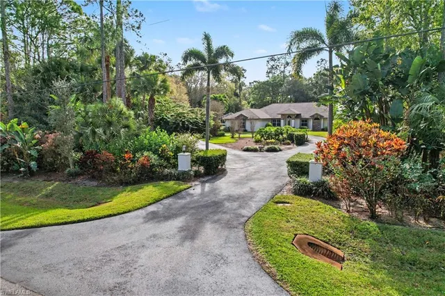 an aerial view of a house with swimming pool and garden