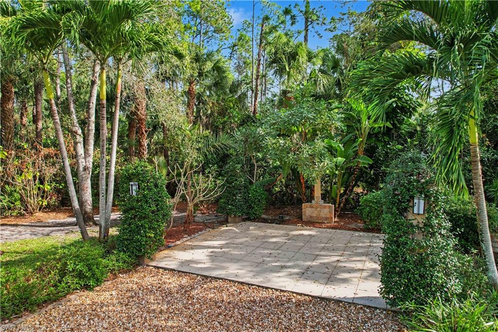 5186 Tallowood Way Naples, FL 34116 - Photo 48 of 50 a view of a yard with plants and trees