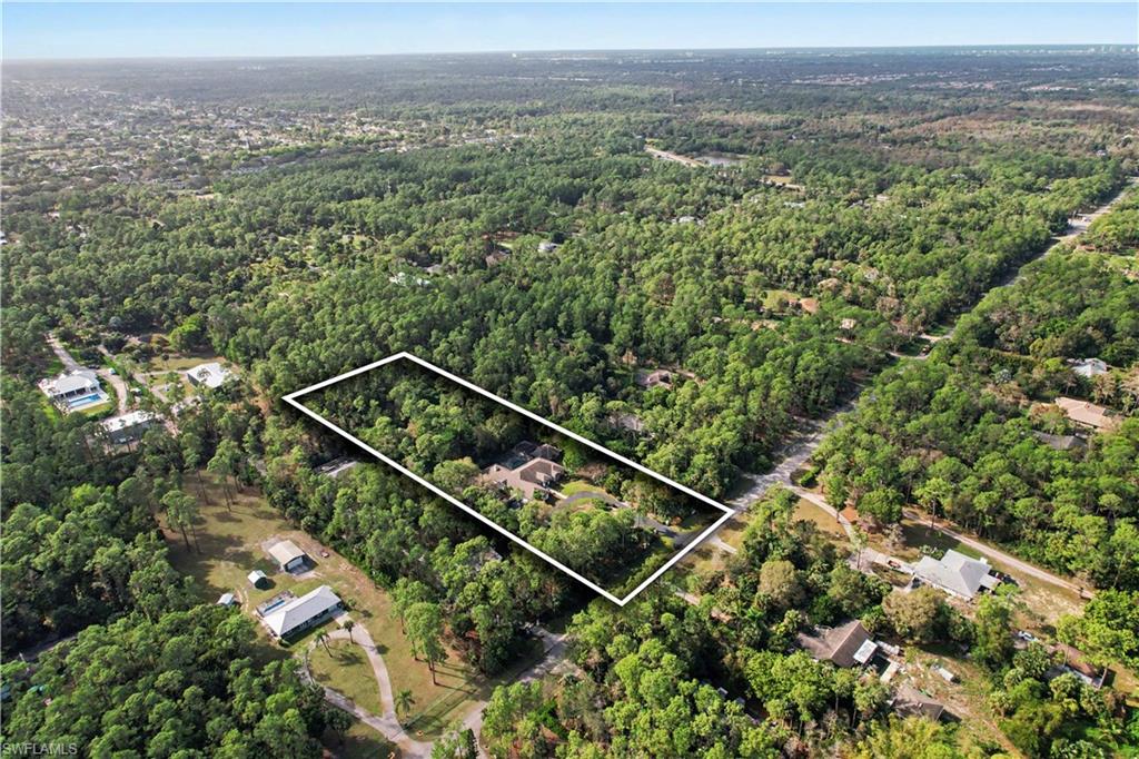 5186 Tallowood Way Naples, FL 34116 - Photo 50 of 50 a view of a city with lush green forest