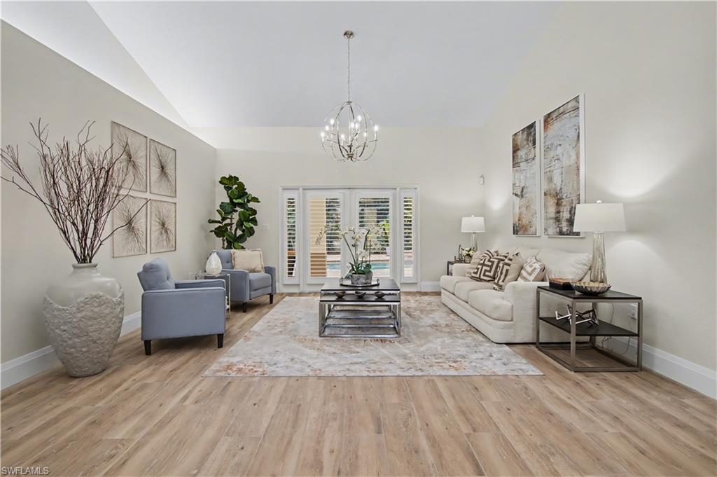5186 Tallowood Way Naples, FL 34116 - Photo 7 of 50 a living room with furniture and wooden floor