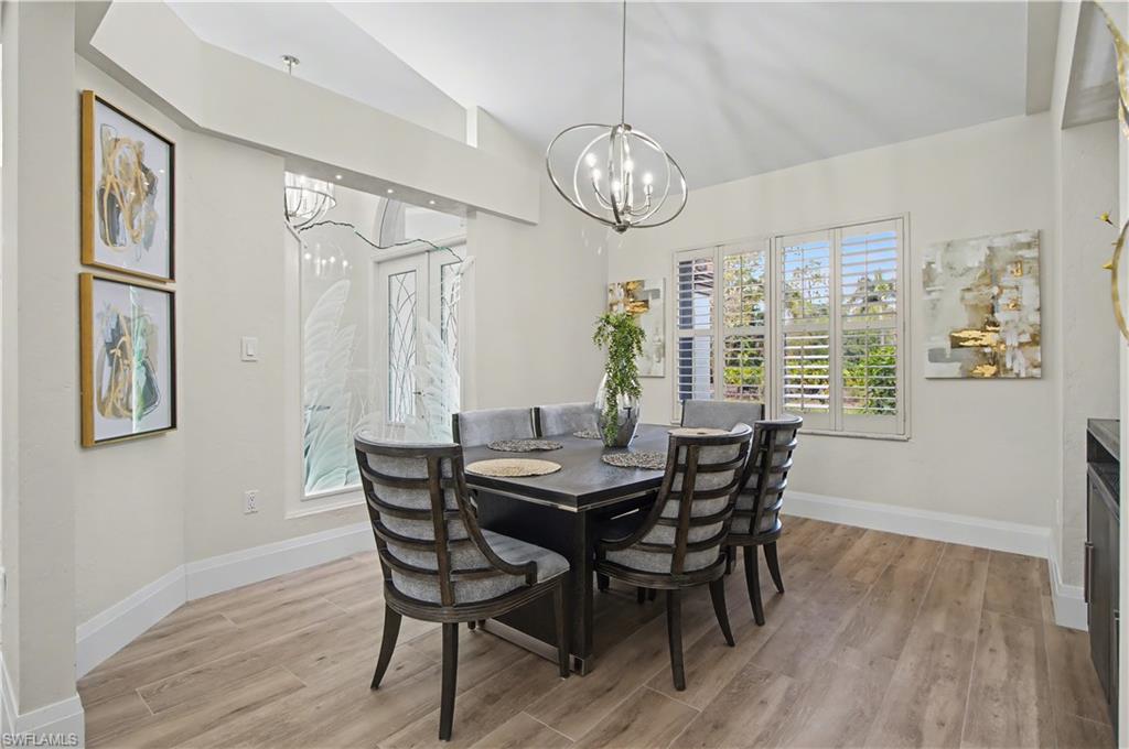 5186 Tallowood Way Naples, FL 34116 - Photo 9 of 50 a view of a dining room with furniture window and wooden floor