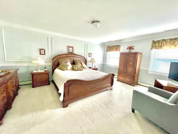 a bedroom with a large bed and a large window