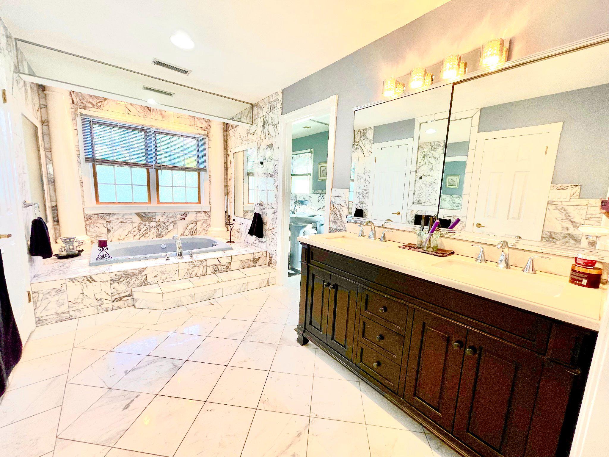 1830 Buck Road Feasterville-Trevose, PA 19053 - Photo 27 of 48 a spacious bathroom with a double vanity sink mirror and bathtub