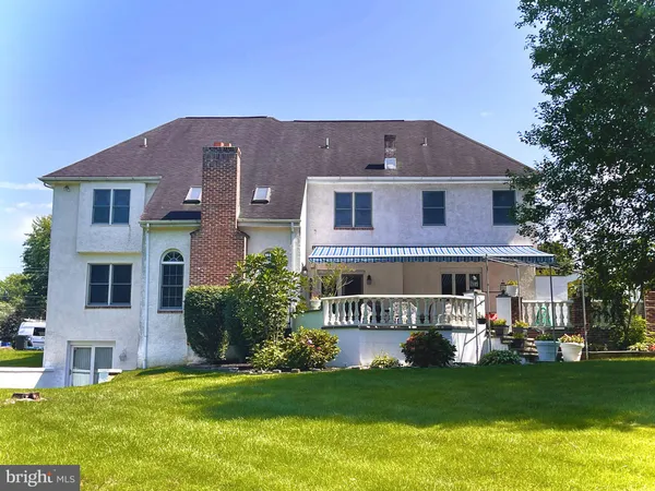 a view of a trees in front of a house with a yard