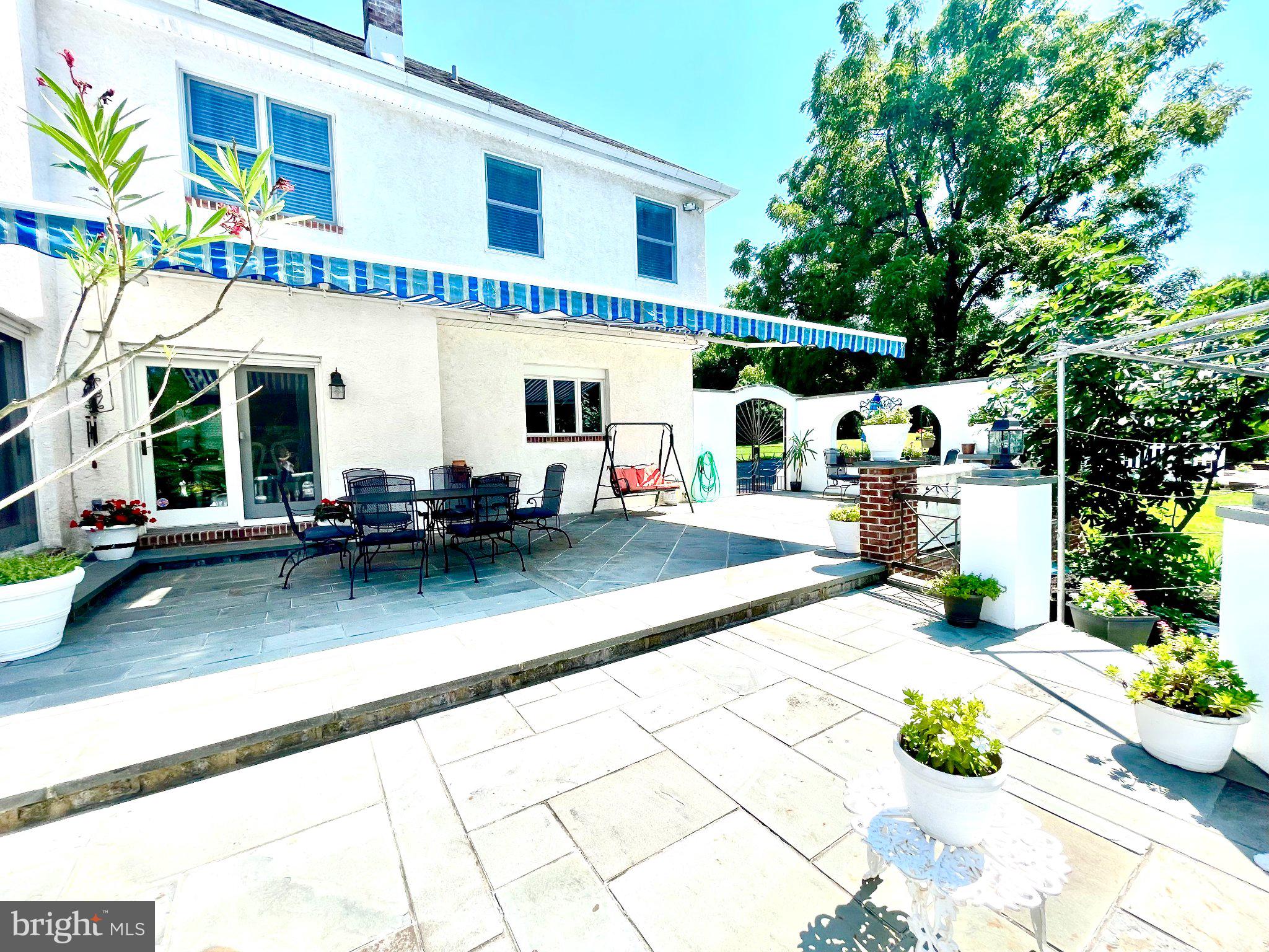 1830 Buck Road Feasterville-Trevose, PA 19053 - Photo 40 of 48 a view of a patio with table and chairs potted plants and large tree