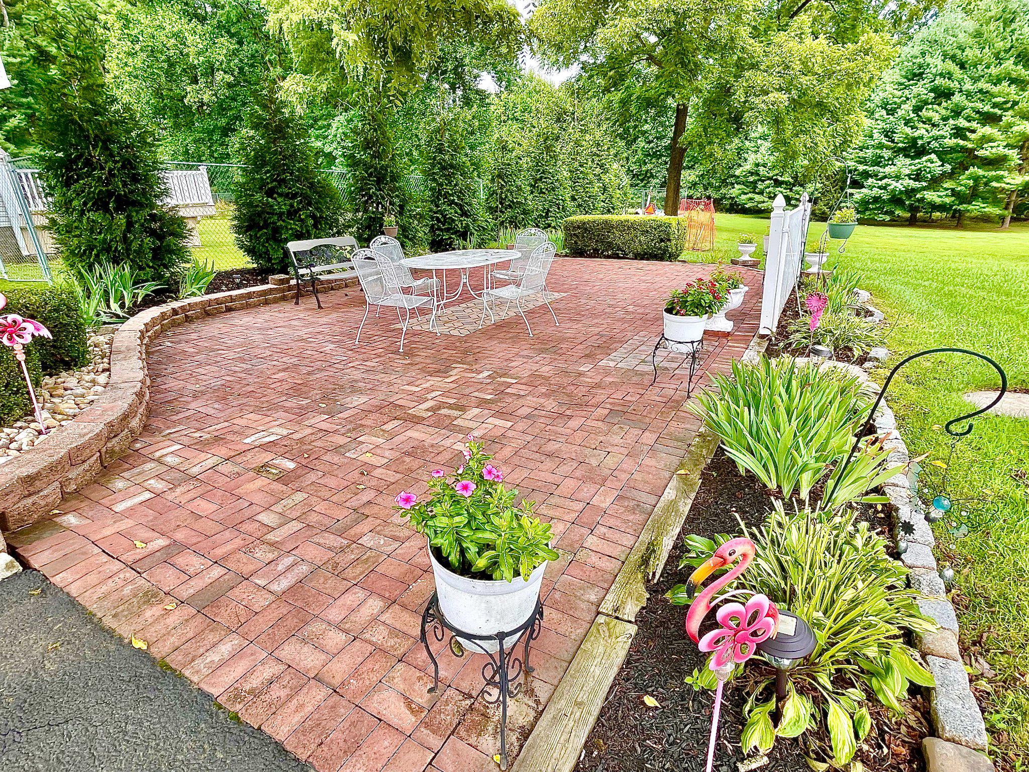 1830 Buck Road Feasterville-Trevose, PA 19053 - Photo 42 of 47 Charming Side Patio Oasis with vibrant blooms.
