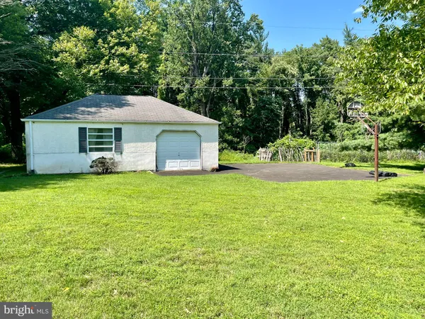 an aerial view of a tennis ground and a cars park side of the road