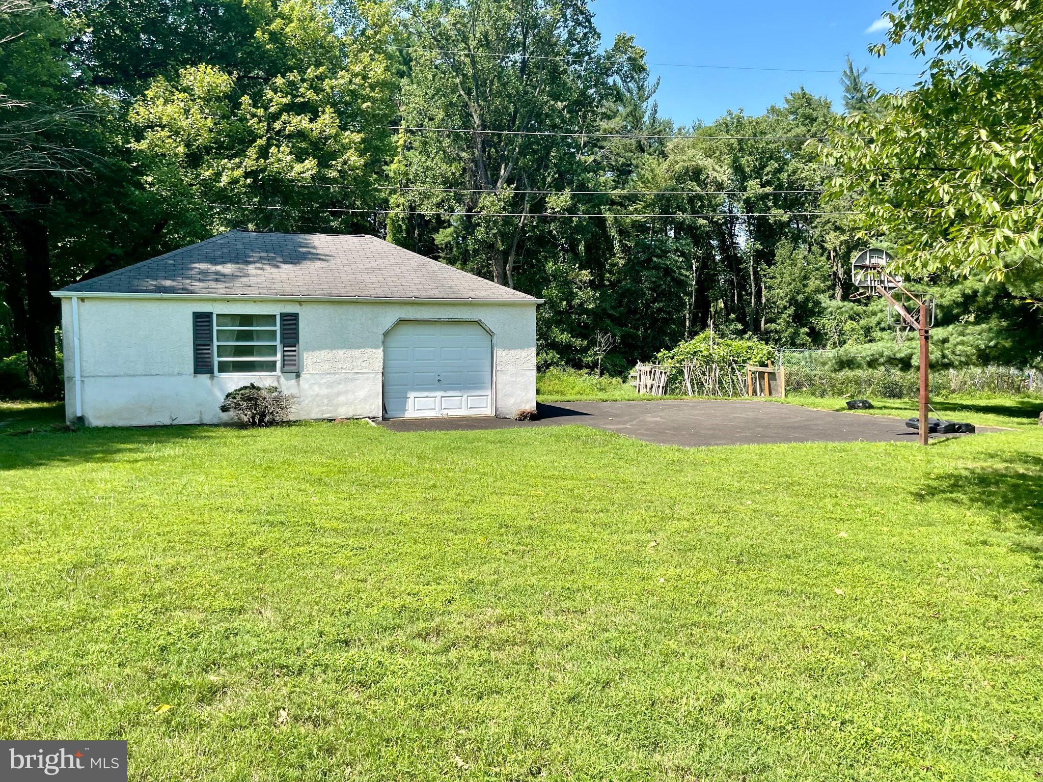 1830 Buck Road Feasterville-Trevose, PA 19053 - Photo 46 of 48 a front view of house with yard and trees