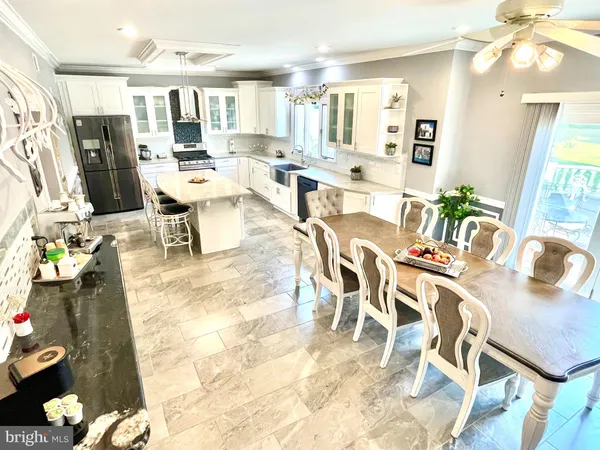 a living room with lots of furniture and a painting on the wall