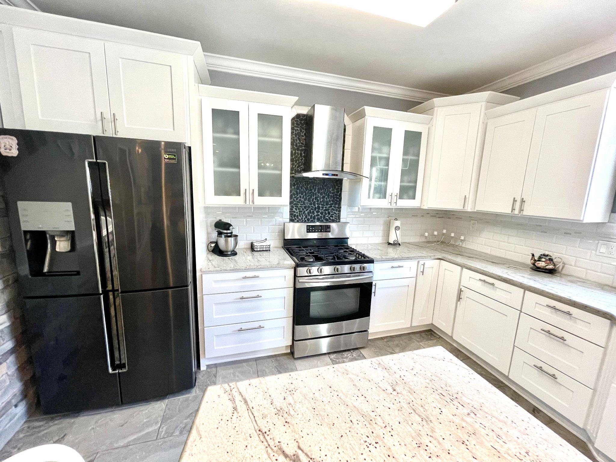 1830 Buck Road Feasterville-Trevose, PA 19053 - Photo 10 of 48 a kitchen with granite countertop a refrigerator stove and cabinets