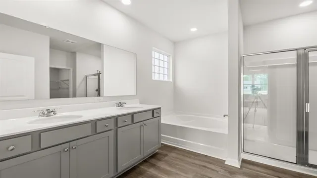 a bath tub sitting next to a white sink