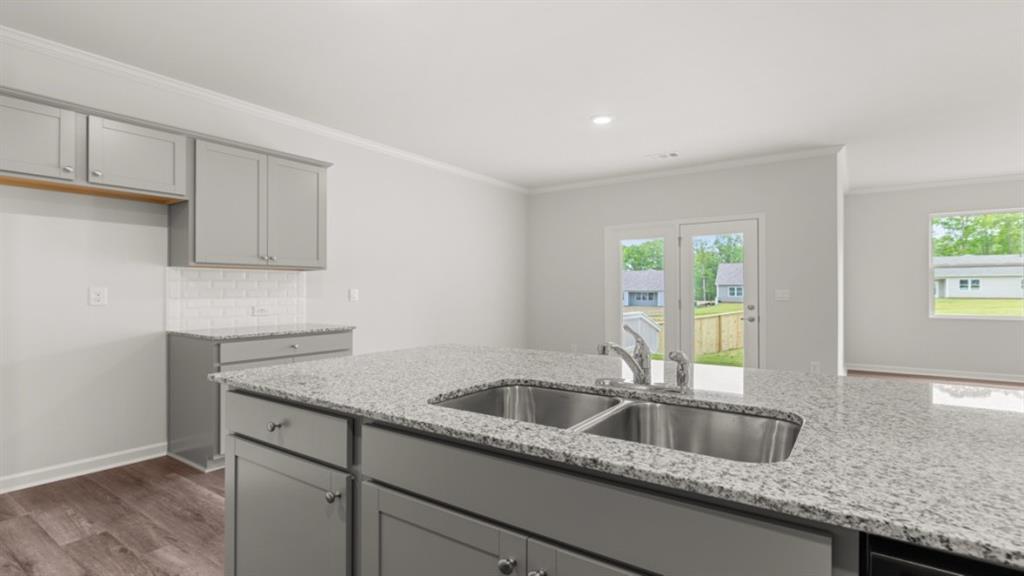 6012 Muirfield Point Union City, GA 30213 - Photo 10 of 37 a kitchen with granite countertop a sink and cabinets