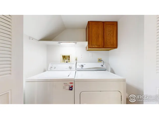 a utility room with sink dryer and washer