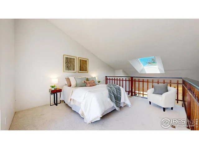 a living room with a bed furniture and a window