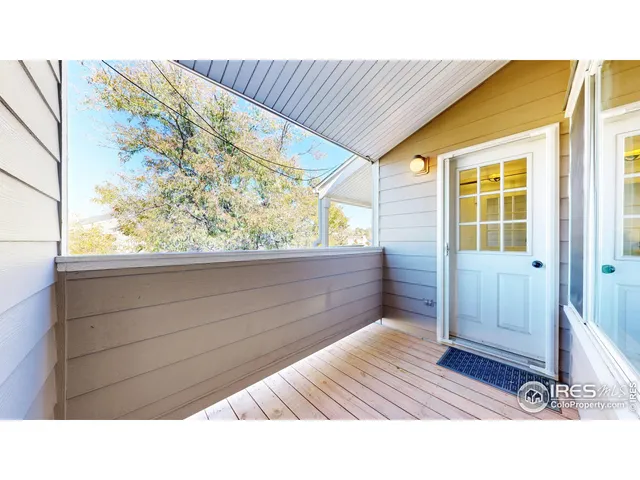 a view of a room with wooden floor and windows