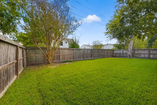 a view of backyard with a garden and entertaining space