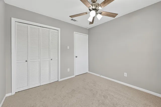 a bathroom with a sink a toilet and a large mirror