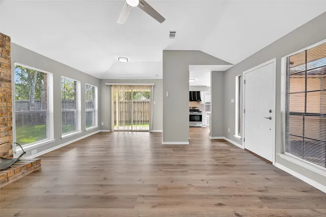 wooden floor in an empty room with a window