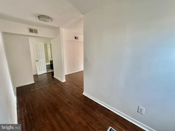 a view of hallway with wooden floor