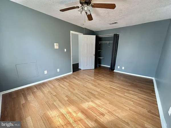 a view of a big room with wooden floor and windows in a room