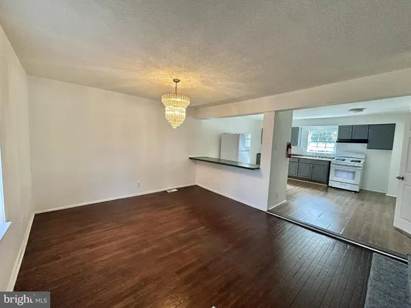 a view of a kitchen with wooden floor and a sink