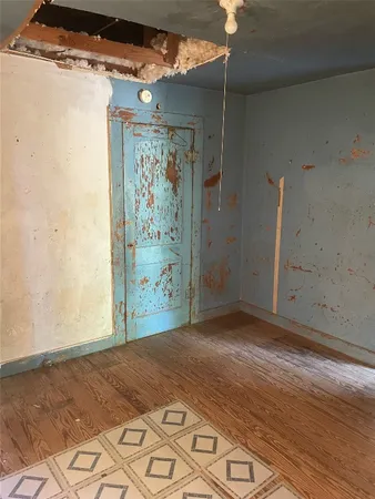 a view of a room with wooden floor