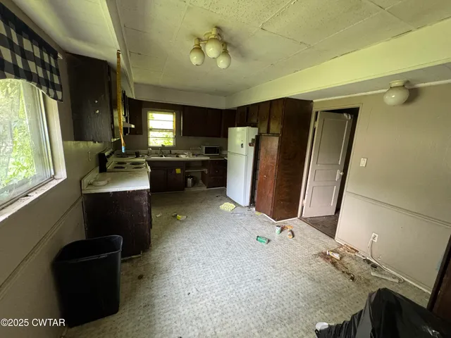 a kitchen with refrigerator and window