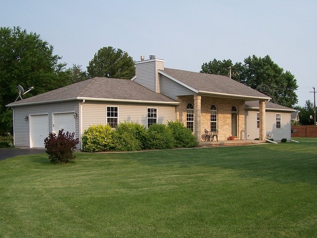 3568 East 28th Road Seneca, IL 61360 - Photo 2 of 19 a front view of a house with a garden