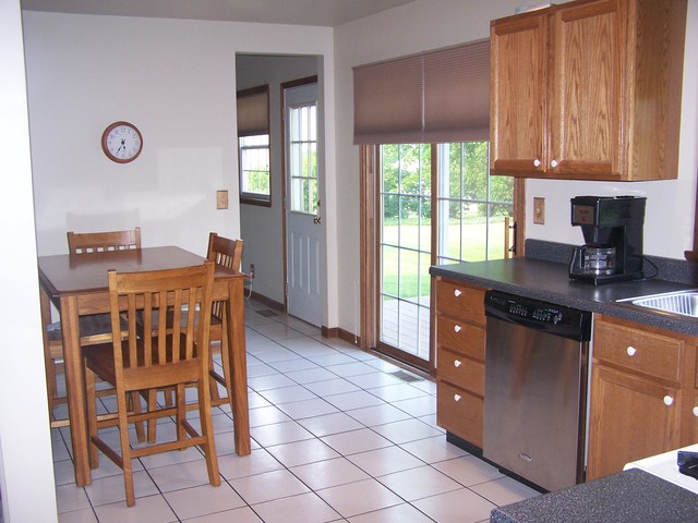 3568 East 28th Road Seneca, IL 61360 - Photo 4 of 19 a kitchen with granite countertop a stove a sink a dining table and chairs