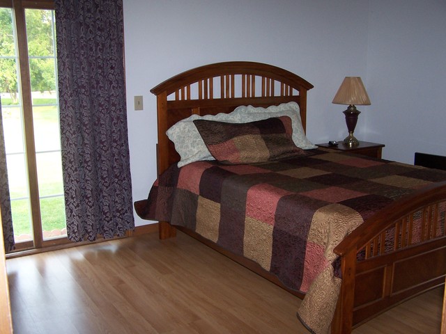 3568 East 28th Road Seneca, IL 61360 - Photo 7 of 19 a bedroom with a bed window and a wooden floor