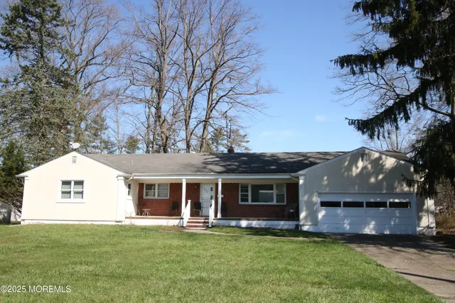 a front view of a house with a garden and yard