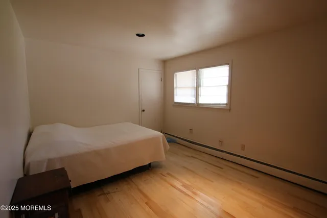 a bed sitting in a bedroom next to a window