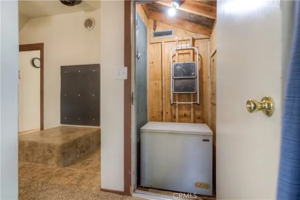 a view of a livingroom with a ceiling fan and window