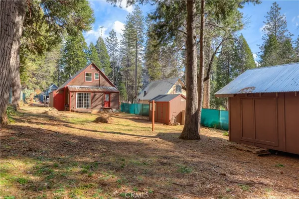 a backyard of a house with yard and outdoor seating