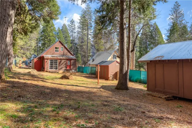 a backyard of a house with yard and outdoor seating