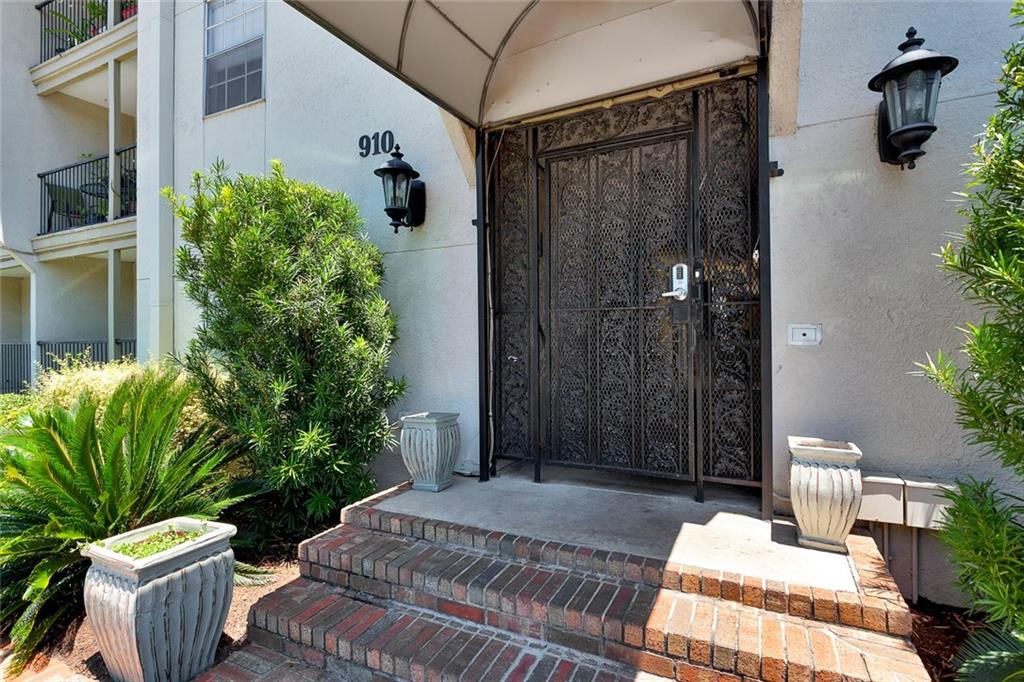 910 Duncan Lane, Unit 35 Austin, TX 78705 - Photo 19 of 20 Secure gated entry welcomes you to this residence, featuring manicured landscaping and a classic brick stairway.