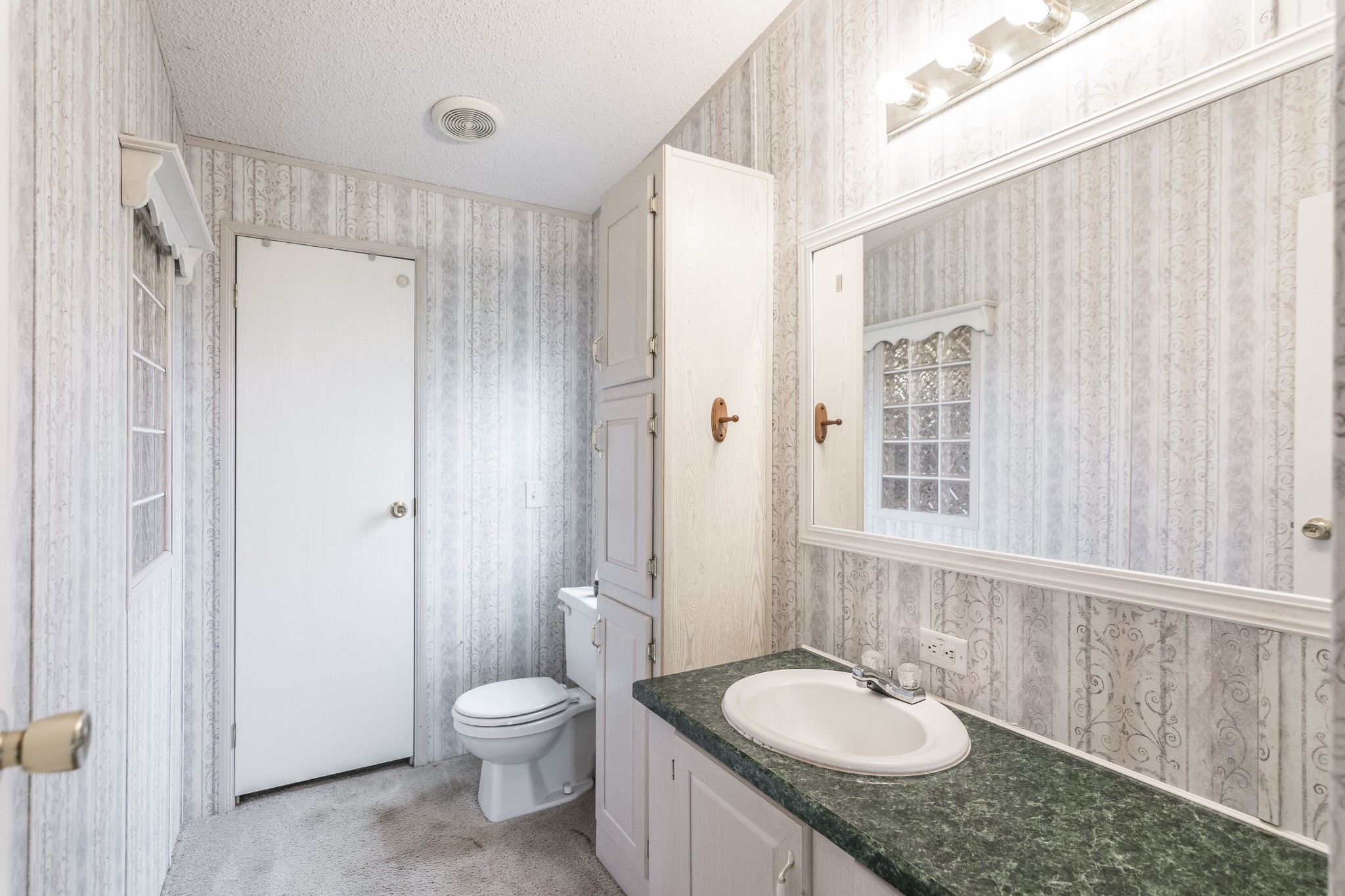 128 East Biggs Road Portland, TN 37148 - Photo 22 of 43 a bathroom with a granite countertop sink toilet a mirror and shower